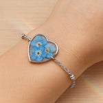 Bracciale donna cuore terrarium fiori veri forget me not azzurri Ciondolo resina catenella acciaio regolabile taglia unica.Gioielli resina