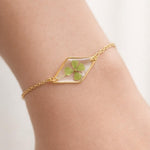 Terrarium woman bracelet real flower four-leaf clover lucky charm Resin pendant adjustable steel chain one size.Resin jewels