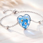 Bracciale donna cuore terrarium fiori veri forget me not azzurri Ciondolo resina catenella acciaio regolabile taglia unica.Gioielli resina